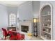 Elegant living room with a fireplace, decorative shelving, and comfortable seating at 17 Hibiscus Ct, Eustis, FL 32726