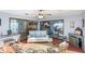 Bright sunroom featuring neutral décor, a keyboard, comfortable seating, and sliding doors to the home's interior at 17 Hibiscus Ct, Eustis, FL 32726