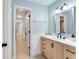 Stylish bathroom with a modern vanity, a large mirror and neutral walls at 17 Lawn St, Oviedo, FL 32765