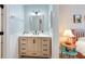 Stylish bathroom with a modern vanity, a large mirror, neutral walls, and interior door at 17 Lawn St, Oviedo, FL 32765