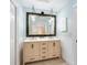 Bathroom featuring a modern vanity with double sinks, stylish fixtures and mirrors at 17 Lawn St, Oviedo, FL 32765