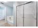 Bathroom with a tub and shower featuring modern fixtures, and tile flooring at 17 Lawn St, Oviedo, FL 32765