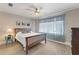 Cozy bedroom featuring wood floors, neutral paint, ceiling fan and a large window at 17 Lawn St, Oviedo, FL 32765