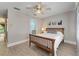 Bedroom featuring wood floors, neutral paint, ceiling fan, artwork and interior door at 17 Lawn St, Oviedo, FL 32765