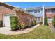 Charming townhouse with brick facade, lush landscaping, and a well-maintained front yard at 17 Lawn St, Oviedo, FL 32765