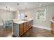 Inviting kitchen featuring ample counter space, warm wood cabinetry, and a cozy breakfast bar with room to entertain at 17 Lawn St, Oviedo, FL 32765