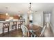 Open-concept kitchen with wooden cabinets, stainless appliances, and adjacent breakfast nook at 17 Lawn St, Oviedo, FL 32765