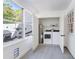 Bright laundry room with modern washer and dryer, water heater, and natural light at 17 Lawn St, Oviedo, FL 32765