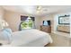 Bright main bedroom with hardwood floors, a ceiling fan, and sliding doors to the balcony at 17 Lawn St, Oviedo, FL 32765