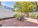Outdoor patio featuring brick pavers, privacy fence, landscaping, and outdoor seating at 17 Lawn St, Oviedo, FL 32765