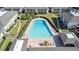 Aerial view of community pool surrounded by lush lawns and multiple residential buildings at 1935 Conway Rd # R5, Orlando, FL 32812