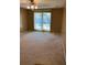 Carpeted bedroom with large windows and a ceiling fan with light fixture at 1935 Conway Rd # R5, Orlando, FL 32812