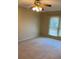 A standard bedroom with a ceiling fan, a window with blinds, and carpeted flooring at 1935 Conway Rd # R5, Orlando, FL 32812