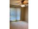A standard bedroom with a ceiling fan, a window with blinds, and carpeted flooring at 1935 Conway Rd # R5, Orlando, FL 32812