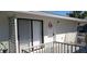 Exterior shot of a condo entrance with sliding glass doors, a wreath, and a small balcony at 1935 Conway Rd # R5, Orlando, FL 32812