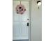 Entrance with a pink floral wreath hanging on the door and with a visible unit number at 1935 Conway Rd # R5, Orlando, FL 32812