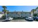 Two-story condo building showing parking lot with reserved parking spaces and manicured landscaping at 1935 Conway Rd # R5, Orlando, FL 32812