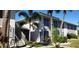 A condo building with stairs, landscaping, and a clean exterior with palm trees in the background at 1935 Conway Rd # R5, Orlando, FL 32812