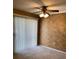 Carpeted living room with textured walls, vertical blinds, and a ceiling fan with light fixture at 1935 Conway Rd # R5, Orlando, FL 32812