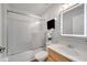 Bright white bathroom with glass-enclosed shower, modern lighted mirror, and wood vanity at 2026 Cypress Bay Blvd, Kissimmee, FL 34743