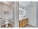Bathroom with double sinks, a large mirror and a toilet at 2026 Cypress Bay Blvd, Kissimmee, FL 34743
