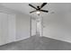 Carpeted bedroom featuring a ceiling fan and closet space at 2026 Cypress Bay Blvd, Kissimmee, FL 34743
