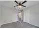 Neutral bedroom featuring plush gray carpeting, bright interior, and closet at 2026 Cypress Bay Blvd, Kissimmee, FL 34743
