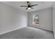 Carpeted bedroom with a ceiling fan and a view to the exterior at 2026 Cypress Bay Blvd, Kissimmee, FL 34743
