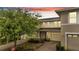 Charming townhouse with a brick-paved driveway, lush landscaping, and a home for sale sign at 2026 Cypress Bay Blvd, Kissimmee, FL 34743