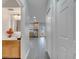 Hallway view including a full bath, linen closet, and a kitchen in a home with gray wood flooring at 2026 Cypress Bay Blvd, Kissimmee, FL 34743