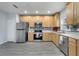 A full kitchen with stainless steel appliances and lots of wooden cabinets at 2026 Cypress Bay Blvd, Kissimmee, FL 34743