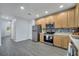 Bright kitchen with stainless steel appliances, wood cabinets, and mosaic backsplash at 2026 Cypress Bay Blvd, Kissimmee, FL 34743