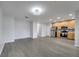 Open floor plan with wood-look floors, a living room, and a kitchen area at 2026 Cypress Bay Blvd, Kissimmee, FL 34743
