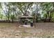 Backyard with a charming gazebo, outdoor grill, and picnic table at 216 Clara Vista St, Debary, FL 32713