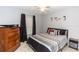 Comfortable bedroom with a ceiling fan, window, dresser, and stylish decor at 216 Clara Vista St, Debary, FL 32713