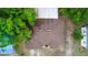 Overhead view of a well-maintained roof on a home surrounded by lush trees in a residential area at 216 Clara Vista St, Debary, FL 32713