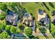 An aerial view showing the property layout and a well maintained lawn with nearby pools at 2230 Lake Crescent Ct, Windermere, FL 34786