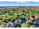 An aerial view showing a community surrounded by trees and a lake at 2230 Lake Crescent Ct, Windermere, FL 34786