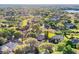 Beautiful aerial view of houses surrounded by lush trees with a lake in the background at 2230 Lake Crescent Ct, Windermere, FL 34786