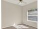 Neutral bedroom with a view to backyard, ceiling fan and neutral carpeted floors at 2230 Lake Crescent Ct, Windermere, FL 34786