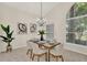 Open dining room featuring a contemporary chandelier, neutral walls, and adjacent views to the front yard at 2230 Lake Crescent Ct, Windermere, FL 34786
