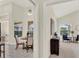 Dining room leading to the living room with large windows and tile flooring at 2230 Lake Crescent Ct, Windermere, FL 34786