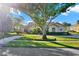 Charming single-story home with a circular driveway and beautifully landscaped front yard, framed by a mature shade tree at 2230 Lake Crescent Ct, Windermere, FL 34786