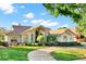 Beautiful single-story home with a circular driveway and manicured landscaping under a partly cloudy blue sky at 2230 Lake Crescent Ct, Windermere, FL 34786