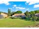 A sunny backyard view of a well-maintained home with a screened-in pool and lush landscaping at 2230 Lake Crescent Ct, Windermere, FL 34786