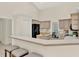 Bright kitchen with a breakfast bar, neutral cabinets, and modern black appliances at 2230 Lake Crescent Ct, Windermere, FL 34786