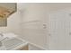 Bright laundry room features a utility sink, shelving, and a washer and dryer hookup at 2230 Lake Crescent Ct, Windermere, FL 34786