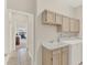 This laundry room features cabinets above the washer and dryer with a utility sink at 2230 Lake Crescent Ct, Windermere, FL 34786