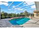 Beautiful screened-in pool with privacy wall, adjacent to a lanai at 2230 Lake Crescent Ct, Windermere, FL 34786