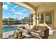 Screened in pool with outdoor sofa and seating area at 2230 Lake Crescent Ct, Windermere, FL 34786